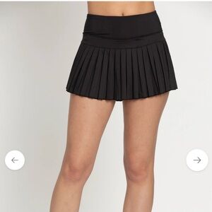 Black Pleated Tennis Skirt with built in spandex short and side pocket.